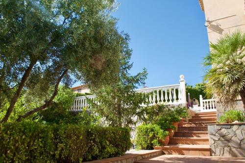 a set of stairs leading to a house with a white railing at El Chalete in Otura