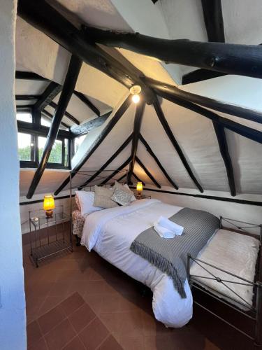 a bedroom with a large bed in a attic at Hotel, Glampings y Cabaña Magic Bungalow in Villa de Leyva