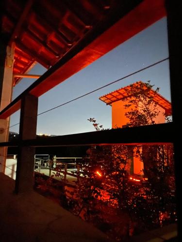 a view of a building from a window at night at Villa Macacos in Nova Lima