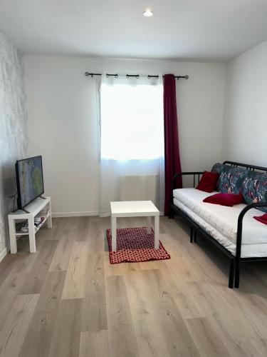 a living room with a couch and a table at Au Trèfle Dort Gîte in Châtel-Guyon