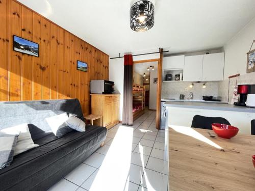 un salon avec un canapé et une cuisine dans l'établissement Résidence Les Balcons Du Charvin - Appartement confortable et proche du village MAE-9274, à Notre-Dame-de-Bellecombe