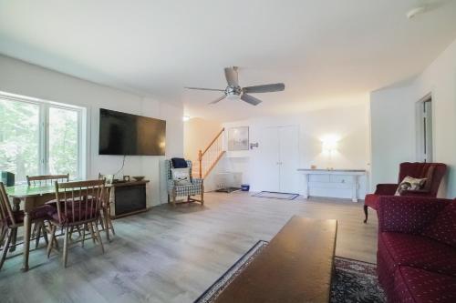 a living room with a table and a ceiling fan at Cedar Hall in Bumpass