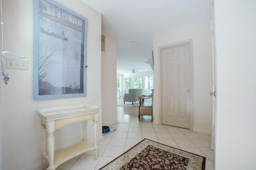 a white hallway with a sink and a table at Cedar Hall in Bumpass