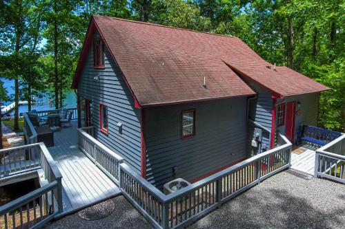 a small house with a red roof and a porch at Cedar Hall in Bumpass