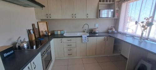 a kitchen with a sink and a counter top at Grace Space in Plattekloof in Cape Town