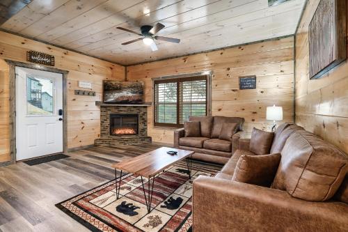 a living room with a couch and a fireplace at Modern 4 Bedroom Cabin in Timeless Resort Near Parkway and Dollywood with Game Room and Hot Tub in Sevierville