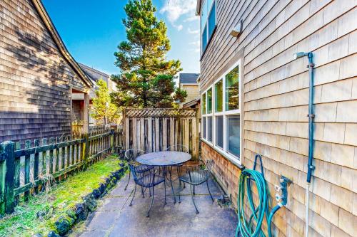 a patio with a table and chairs next to a building at Pacific Shorepine in Pacific City