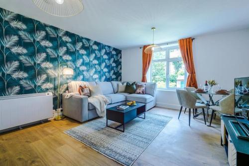 a living room with a couch and a table at ANCHORAGE APARTMENT 5 - Two bed apartment close to the centre and the beach, located in Llandudno, North Wales in Llandudno