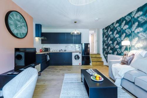 a living room with a white couch and a table at ANCHORAGE APARTMENT 5 - Two bed apartment close to the centre and the beach, located in Llandudno, North Wales in Llandudno