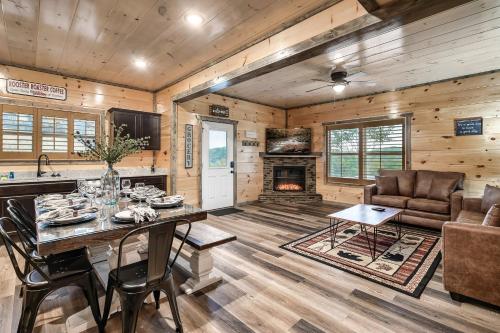 a kitchen and living room with a table and a fireplace at Modern 4 Bedroom Cabin in Timeless Resort Near Parkway and Dollywood with Game Room and Hot Tub in Sevierville