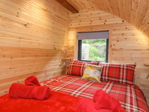 a bedroom with a bed in a log cabin at Hartsop Magic - Crossgate Luxury Glamping in Penrith