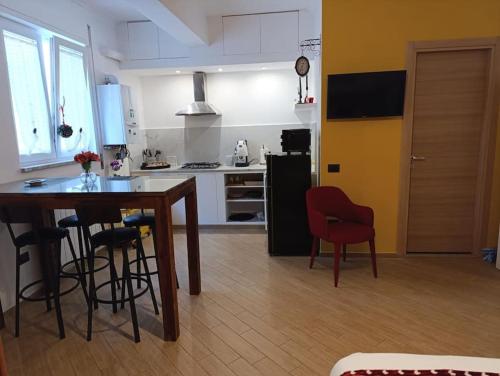 a kitchen with a table and chairs in a room at La Dolce Vita, Vomero in Naples