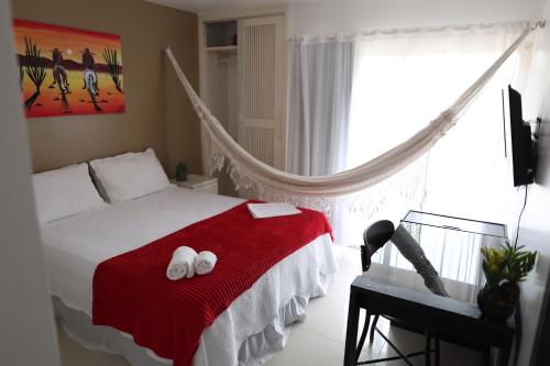 a bedroom with a bed with two white towels on it at FRENTE MAR - Cumbuco - Eco Paradise in Cumbuco