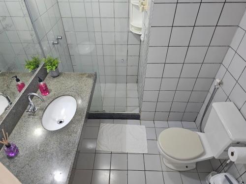 a white bathroom with a toilet and a sink at FRENTE MAR - Cumbuco - Eco Paradise in Cumbuco