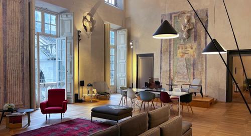 a living room with a couch and a table and chairs at Hotel Palazzo Grillo in Genova
