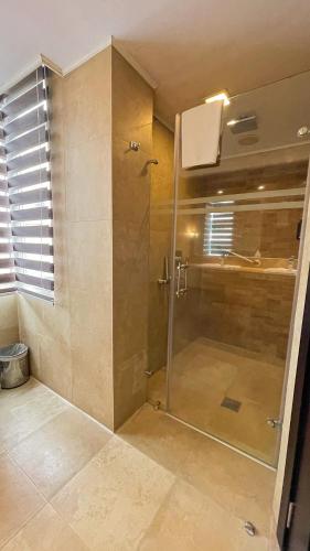 a shower with a glass door in a bathroom at Mercure Alameda Quito in Quito