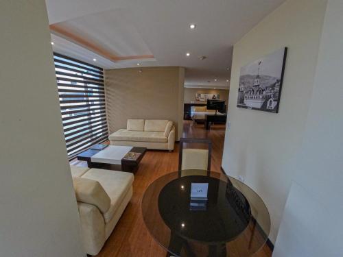a living room with a couch and a table at Mercure Alameda Quito in Quito