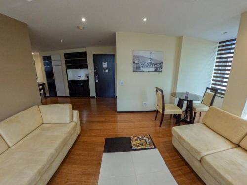 a living room with a couch and a table at Mercure Alameda Quito in Quito