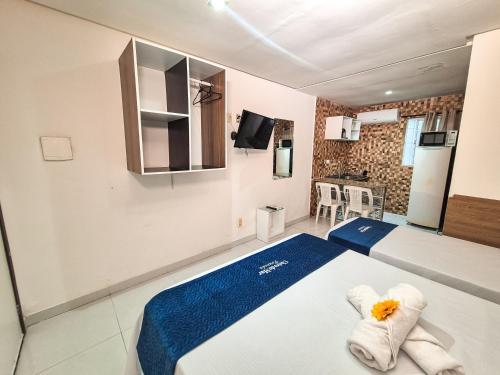 a room with a bed with towels on it at Pousada Cheiro do Mar in Porto De Galinhas