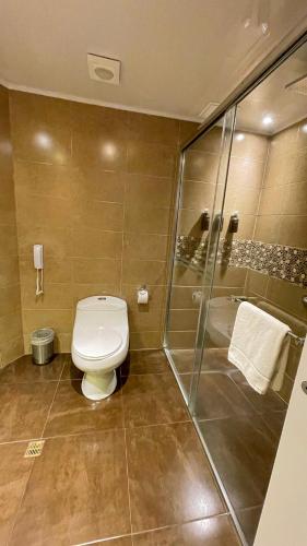 a bathroom with a toilet and a shower at Mercure Alameda Quito in Quito