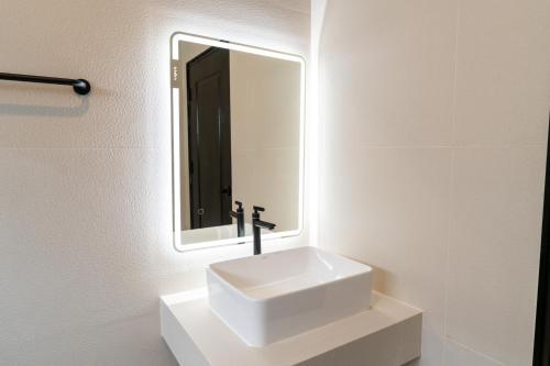 a bathroom with a white sink and a mirror at House 158 Patong Pool Villa 4BR Near Beach in Patong Beach