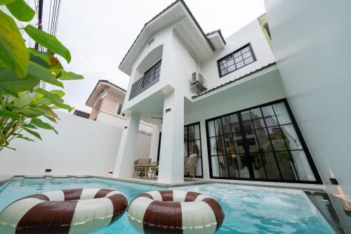 a house with a swimming pool in front of it at House 158 Patong Pool Villa 4BR Near Beach in Patong Beach