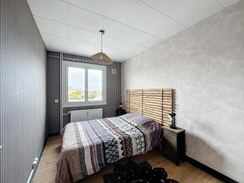 une chambre avec un lit et une fenêtre dans l'établissement L'air marin, à Ouistreham