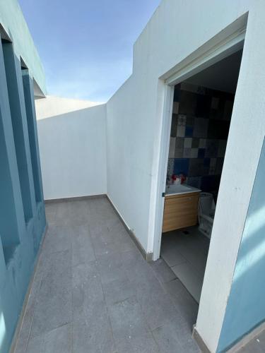 an empty hallway with a bathroom with a sink at Samana Complexes Los Robles VII in Los Paredones