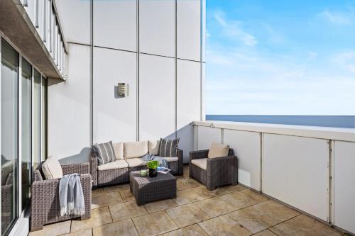 a balcony with chairs and a couch on a building at Strand-Penthouse, 128 qm, Maisonette, Parkplatz in Wilhelmshaven