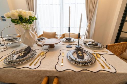 a dining table with plates and utensils on it at House 158 Patong Pool Villa 4BR Near Beach in Patong Beach
