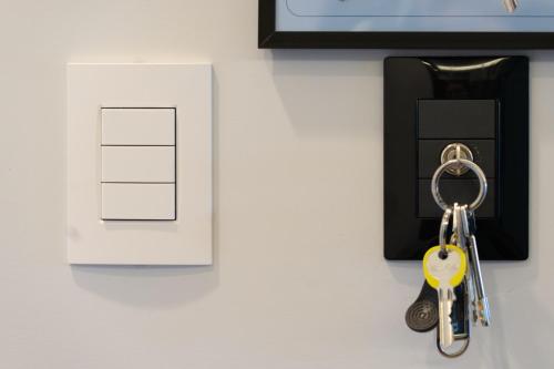 a pair of keys on a table next to a card at HOLIDAYS HOMES ROME GOLF Appartamenti Marco Simone AeB in Marco Simone