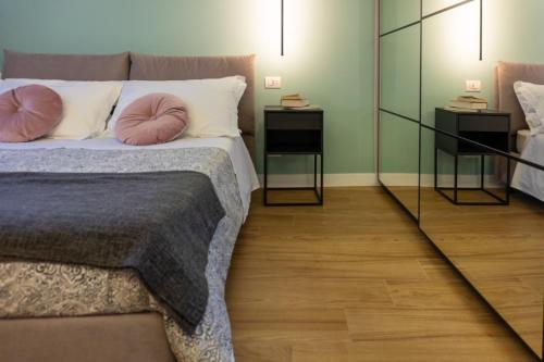 a bedroom with a bed and two night stands at HOLIDAYS HOMES ROME GOLF Appartamenti Marco Simone AeB in Marco Simone