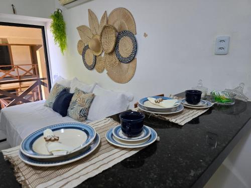 a living room with a table with plates on it at FRENTE MAR - Cumbuco - Eco Paradise in Cumbuco