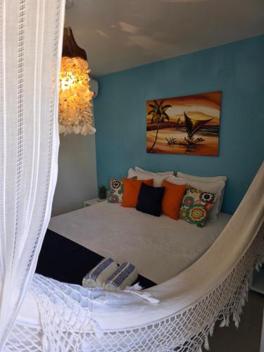 a bedroom with a bed with a hanging net at FRENTE MAR - Cumbuco - Eco Paradise in Cumbuco