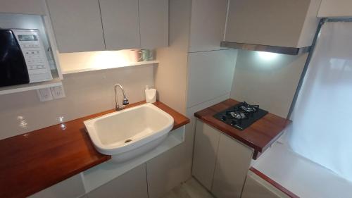 a small kitchen with a sink and a stove at Casa del Condor in San Carlos de Bariloche