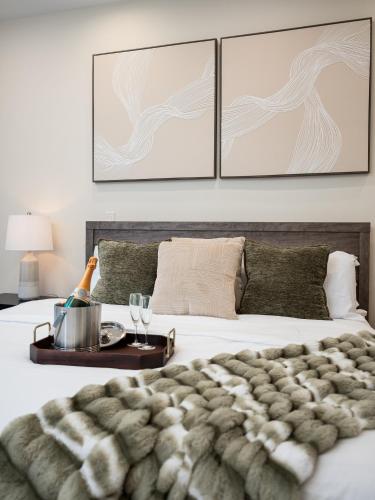 a bedroom with a bed and a table with wine glasses at Thompson Luxuries 4BR Modern Townhome in Rice Military in Houston