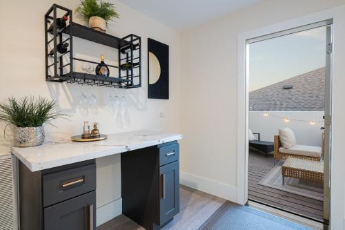 a kitchen with a counter with a sink and a patio at Thompson Luxuries 4BR Modern Townhome in Rice Military in Houston