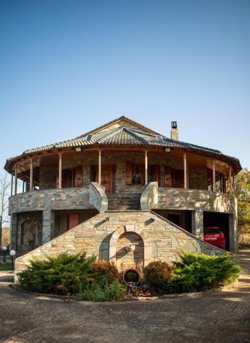 a large building with a stone oven in front of it at Vila Elati Oreini Korinthia in Velína