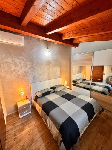 a bedroom with two beds and a wooden ceiling at Turi Agropoli in Agropoli