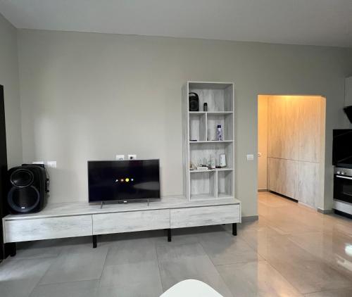 a living room with a flat screen tv on a entertainment center at doa house 2 in Tirana