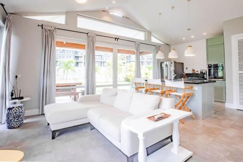 a living room with a white couch and a kitchen at Family Perfect Getaway 3BR Villa 6 at Playa Venao in Playa Venao