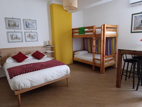 a bedroom with two bunk beds and a desk at La Dolce Vita, Vomero in Naples