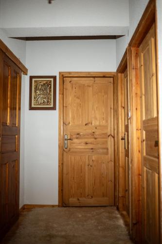 an empty room with a wooden door and white walls at Vila Elati Oreini Korinthia in Velína