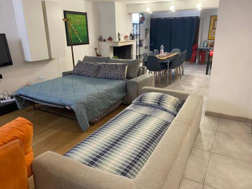 a living room with couches and a table and a couch at Monolocale Zefiro in Elmas
