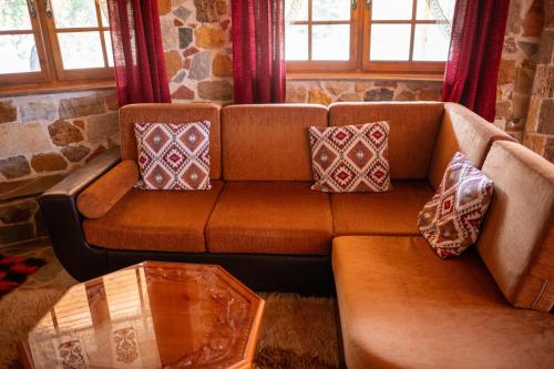 a couch in a living room with pillows on it at Vila Elati Oreini Korinthia in Velína