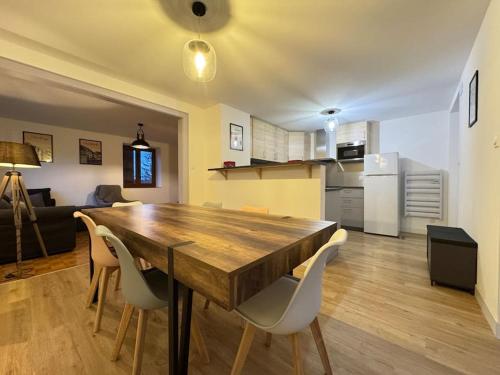 une cuisine et une salle à manger avec une table et des chaises en bois dans l'établissement Havre de paix au cœur des vignes pour 4 à 6 personnes, à Epfig