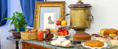 a table topped with different types of bread and fruit at La Luna e i Faló Luxury Accomodation in Turin