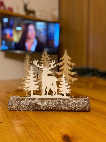 a figurine of a deer and pine trees on a table at Wuthering Heights in Angolo Terme
