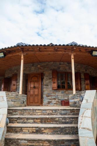 a stone house with stairs in front of it at Vila Elati Oreini Korinthia in Velína
