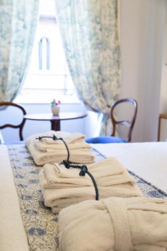 a group of folded towels sitting on a bed at La Luna e i Faló Luxury Accomodation in Turin